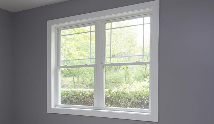 White trimmed window in a grey room.
