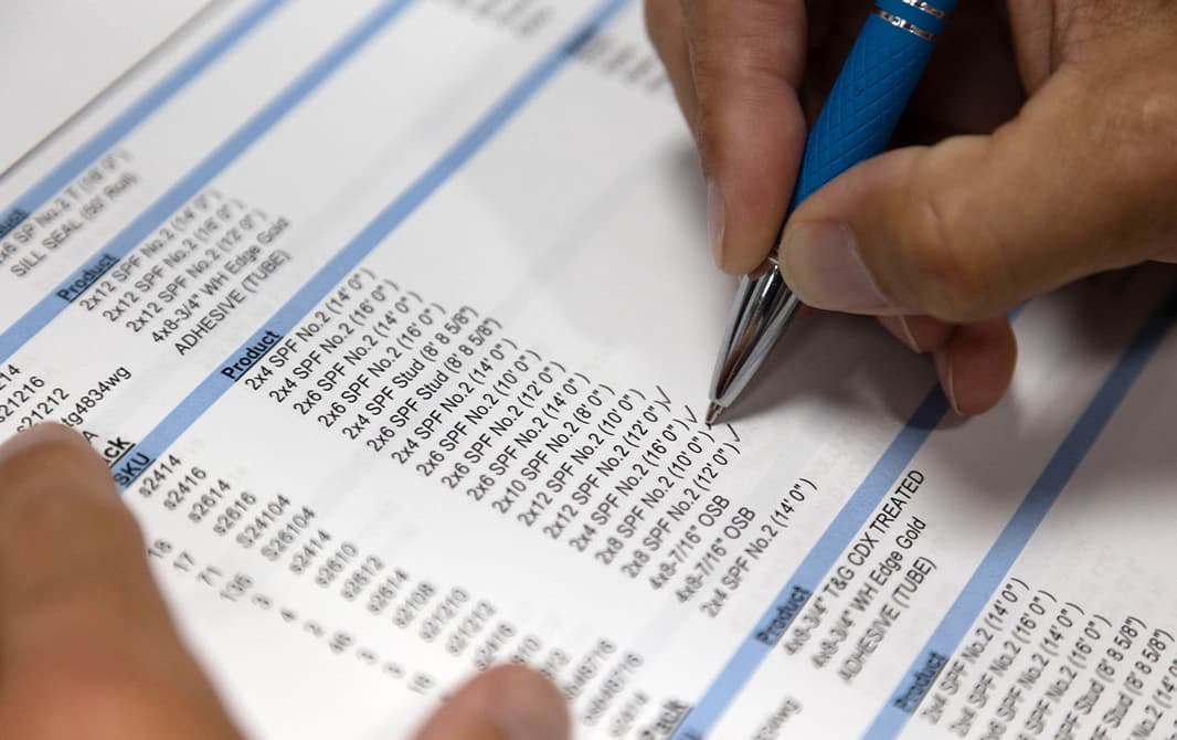 Man checking construction details on a piece of paper.