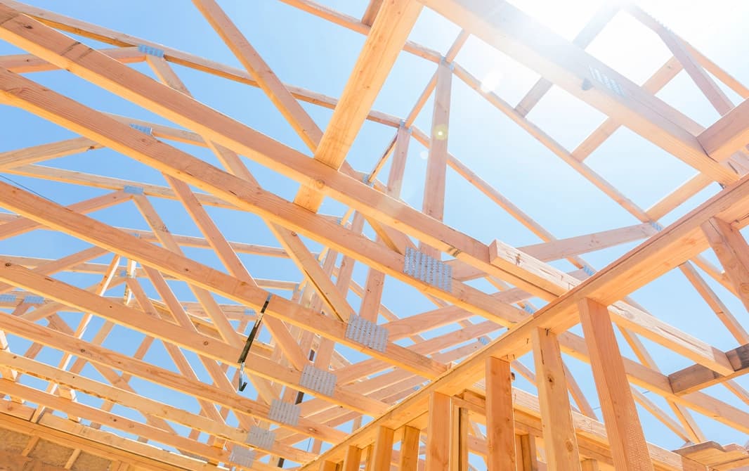 Lumber roof trusses on a construction site.