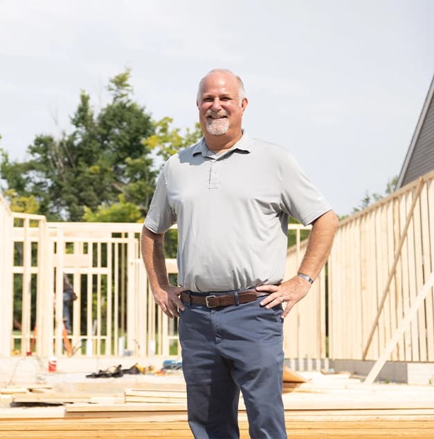 Project manager posting for a photo on a construction site.