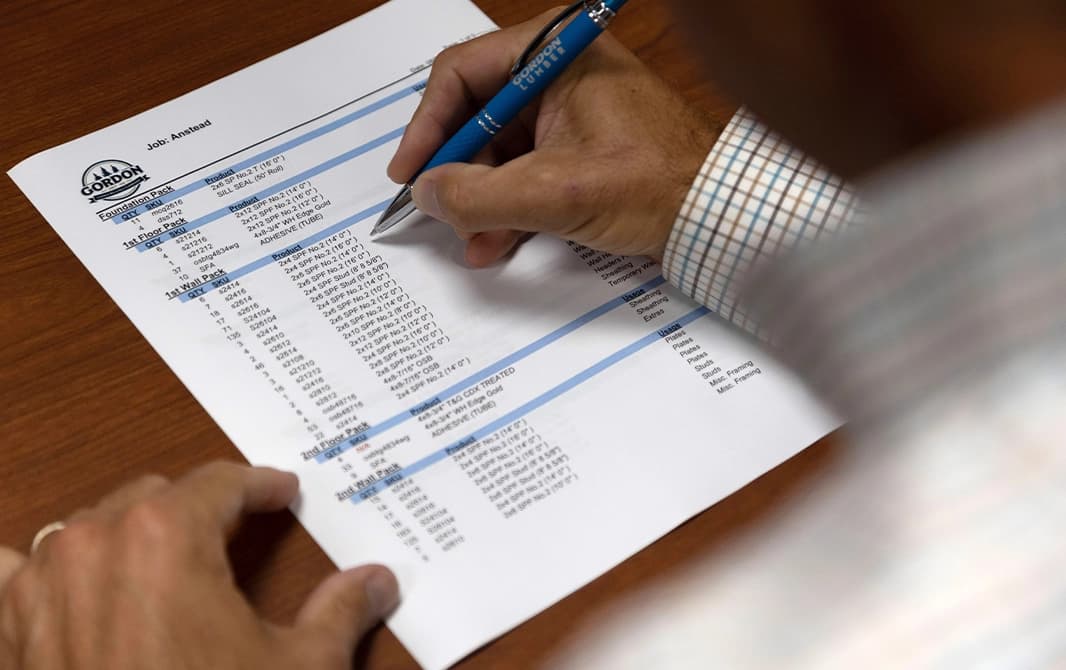 Man looking at construction details on a piece of paper.