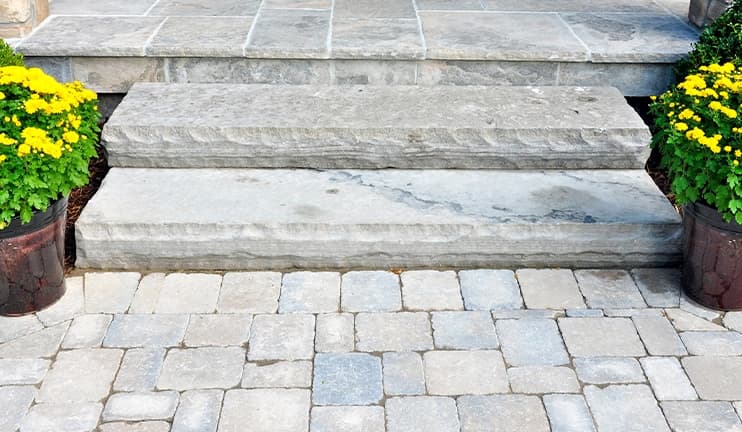 Concrete paving stones leading to steps.