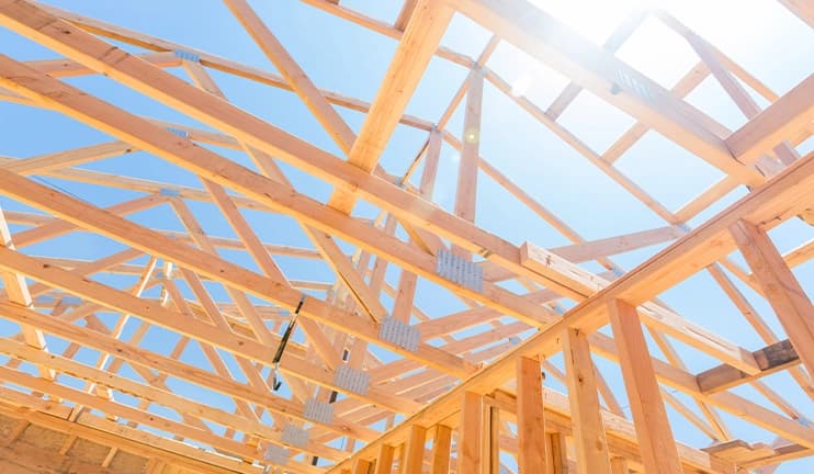 Assembled roof trusses on a construction site.