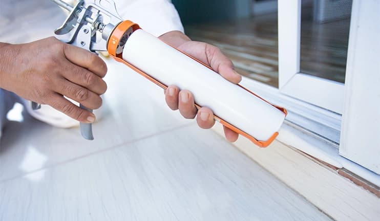 Man holding caulking gun.