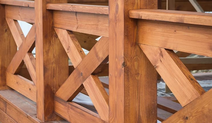 Treated wood fence on a backyard deck.
