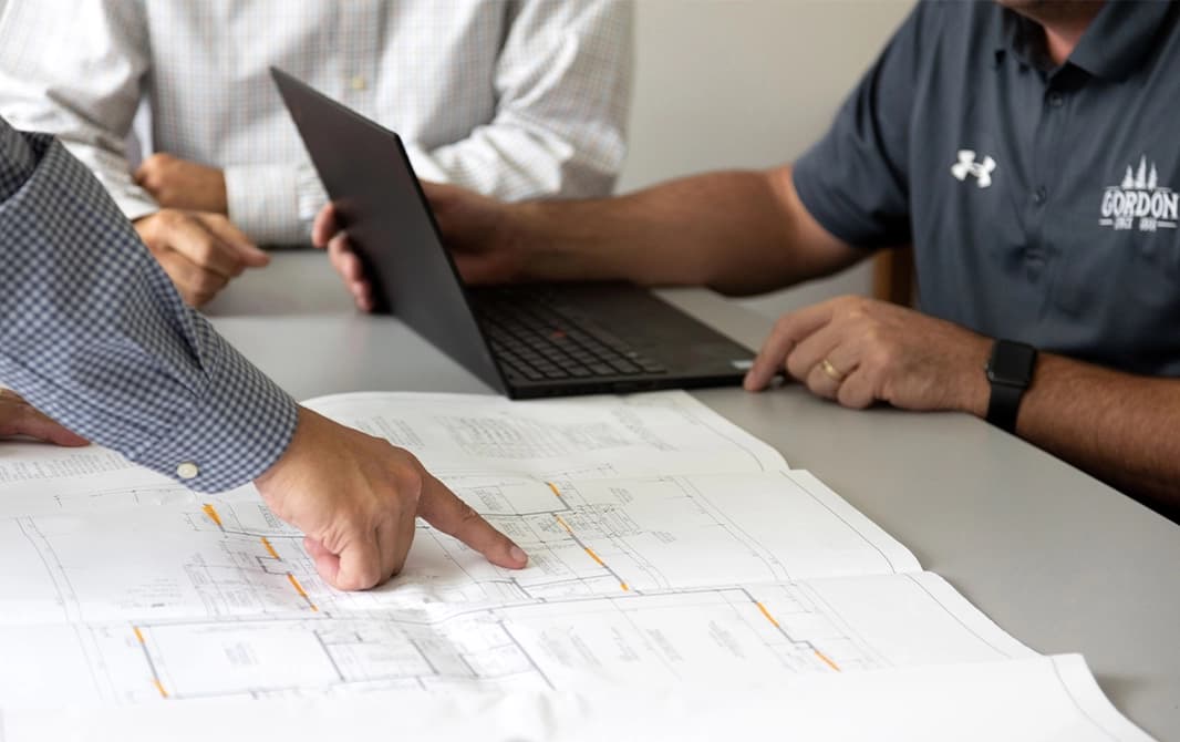 Man pointing out details on a floorplan.